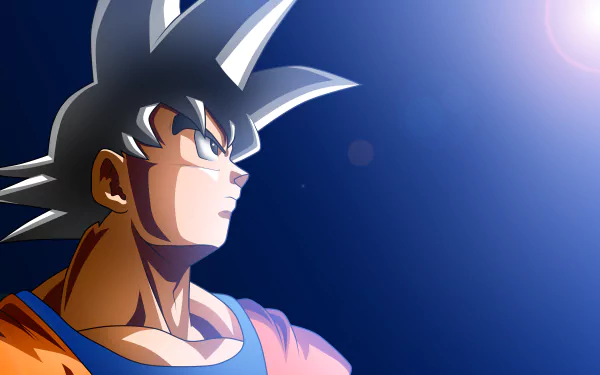 Goku from Dragon Ball Super in sharp detail against a deep blue sky with radiant light, rendered in 8K Ultra HD for PC desktop wallpaper and background.