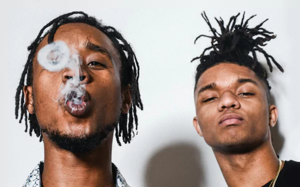 HD desktop wallpaper featuring Rae Sremmurd with one member blowing smoke rings.