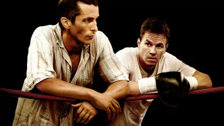 HD desktop wallpaper featuring Christian Bale and Mark Wahlberg in a scene from the movie The Fighter, both leaning on a boxing ring rope.