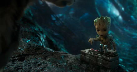HD desktop wallpaper featuring Groot from the movie Guardians of the Galaxy Vol. 2, standing beside a device in a forest setting.
