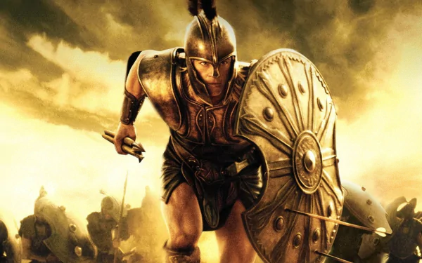 A dynamic HD wallpaper featuring Brad Pitt as a fierce warrior from the movie Troy, capturing the intensity of battle amidst a dramatic backdrop.