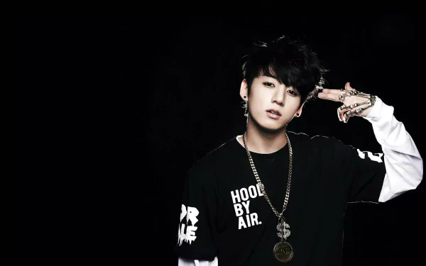 HD desktop wallpaper featuring Jeon Jungkook from BTS, wearing a black and white outfit with gold chains against a black background.