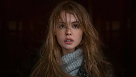 HD desktop wallpaper featuring a brunette Russian model, Anastasiya Scheglova, with tousled hair, wearing a gray turtleneck and leather jacket, gazing directly into the camera.