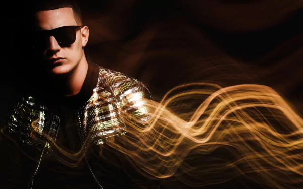 HD desktop wallpaper of a person with sunglasses and a shiny jacket, with golden light trails in the background, tagged with DJ Snake.