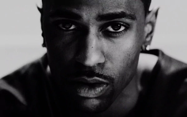 A monochrome HD desktop wallpaper featuring a close-up portrait of a man.