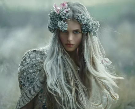 HD PC desktop wallpaper: photographed woman with long white hair and flower crown, wearing ornate garment, ethereal portrait against a soft, blurred background.