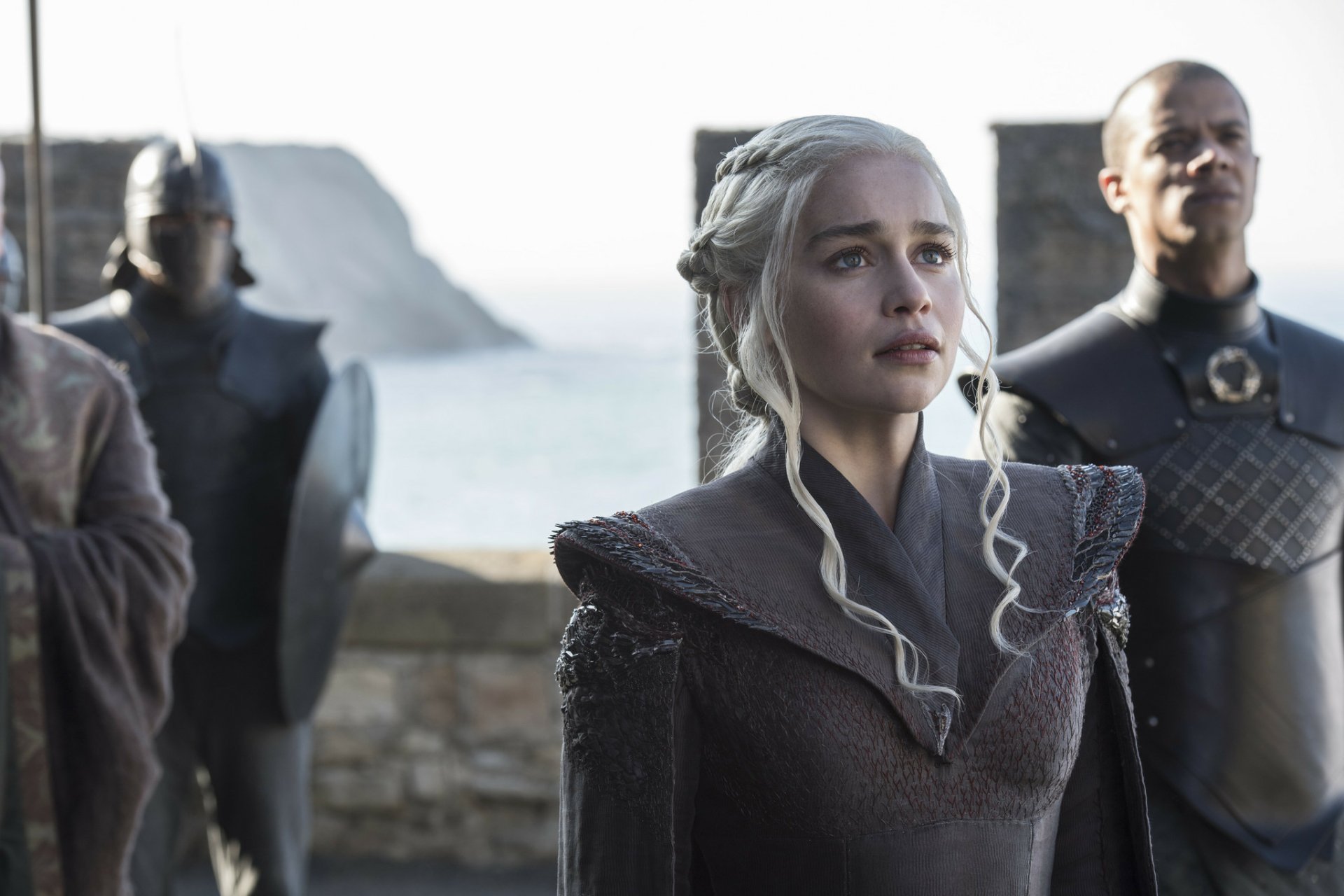 HD wallpaper featuring Emilia Clarke as Daenerys Targaryen and Jacob Anderson as Grey Worm from the TV show Game of Thrones, set against a coastal backdrop.