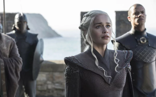 HD wallpaper featuring Emilia Clarke as Daenerys Targaryen and Jacob Anderson as Grey Worm from the TV show Game of Thrones, set against a coastal backdrop.