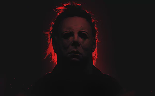 HD desktop wallpaper of Michael Myers from the horror movie Halloween (2007). The silhouette is highlighted with an eerie red glow against a dark background.