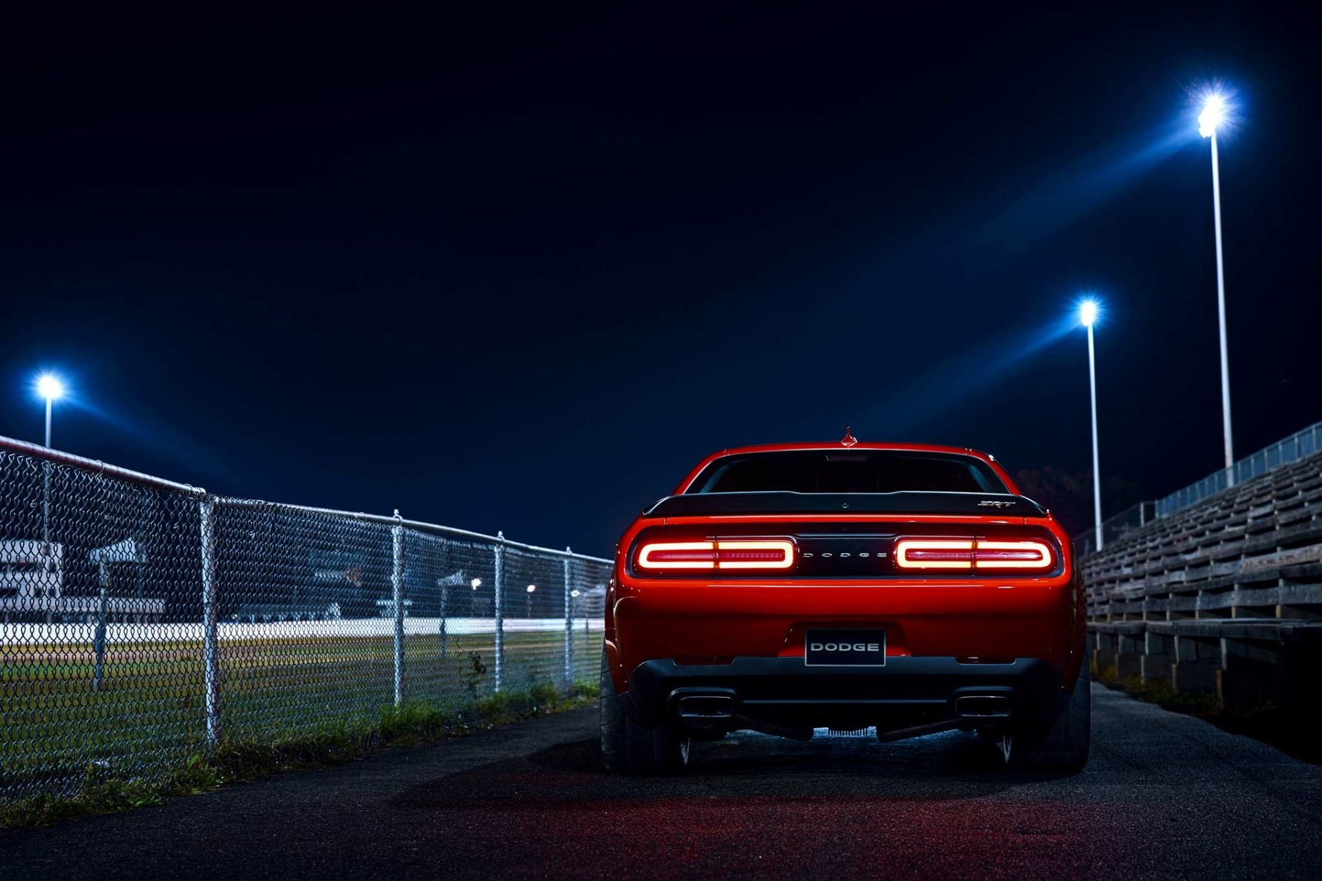 Rear view of a red Dodge Challenger SRT Demon muscle car (Mopar vehicle) under stadium lights — HD PC desktop wallpaper/background.