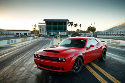Red Dodge Challenger SRT Demon muscle car parked on a racetrack at sunset, featured as an HD PC desktop wallpaper and background.