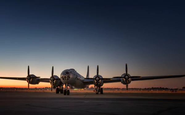 A Boeing B-29 Superfortress warplane sits on the runway at dusk, showcasing its iconic design as a military bomber aircraft under a clear sky.