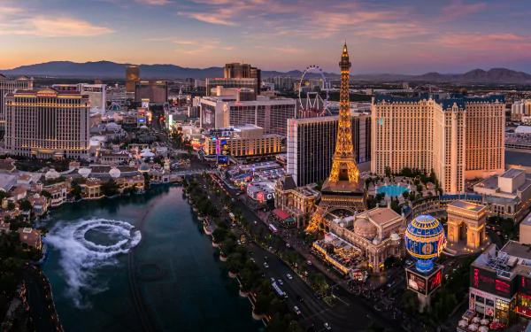 HD PC desktop wallpaper background of the Las Vegas Strip cityscape at dusk, Nevada, USA — man-made skyline of hotels and casinos with an Eiffel Tower replica and fountain along the boulevard.