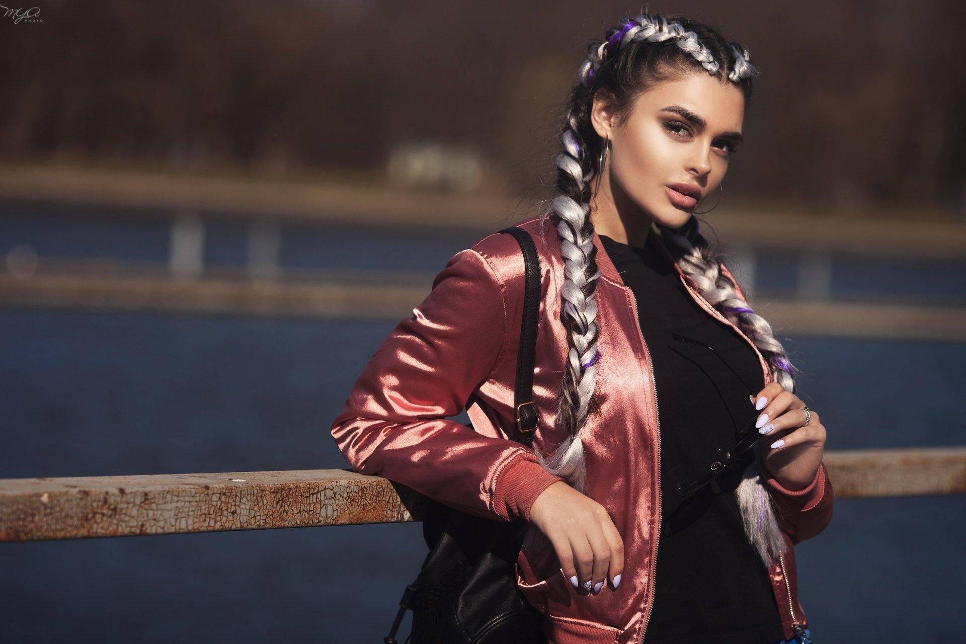 HD desktop wallpaper of a woman model with braided hair, captured with shallow depth of field against a blurred outdoor background.