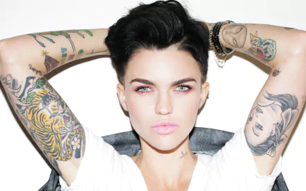 HD desktop wallpaper and background featuring a celebrity with tattoos, tagged as Ruby Rose, posing with hands behind the head.