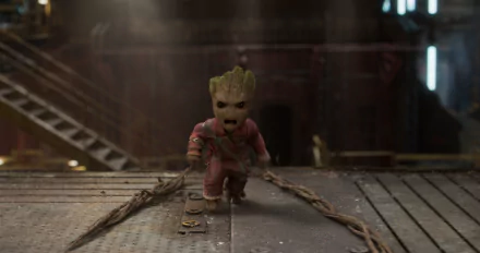 HD wallpaper featuring Baby Groot from the movie Guardians of the Galaxy Vol. 2. The character is in an industrial setting, emphasizing his determined expression.