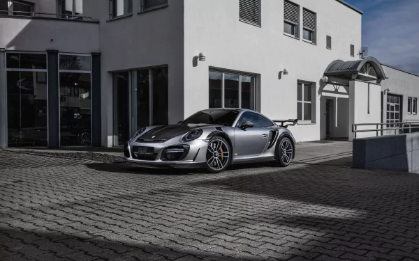 Silver Porsche 911 Turbo parked in front of a modern building, showcased as an HD PC desktop wallpaper and background.