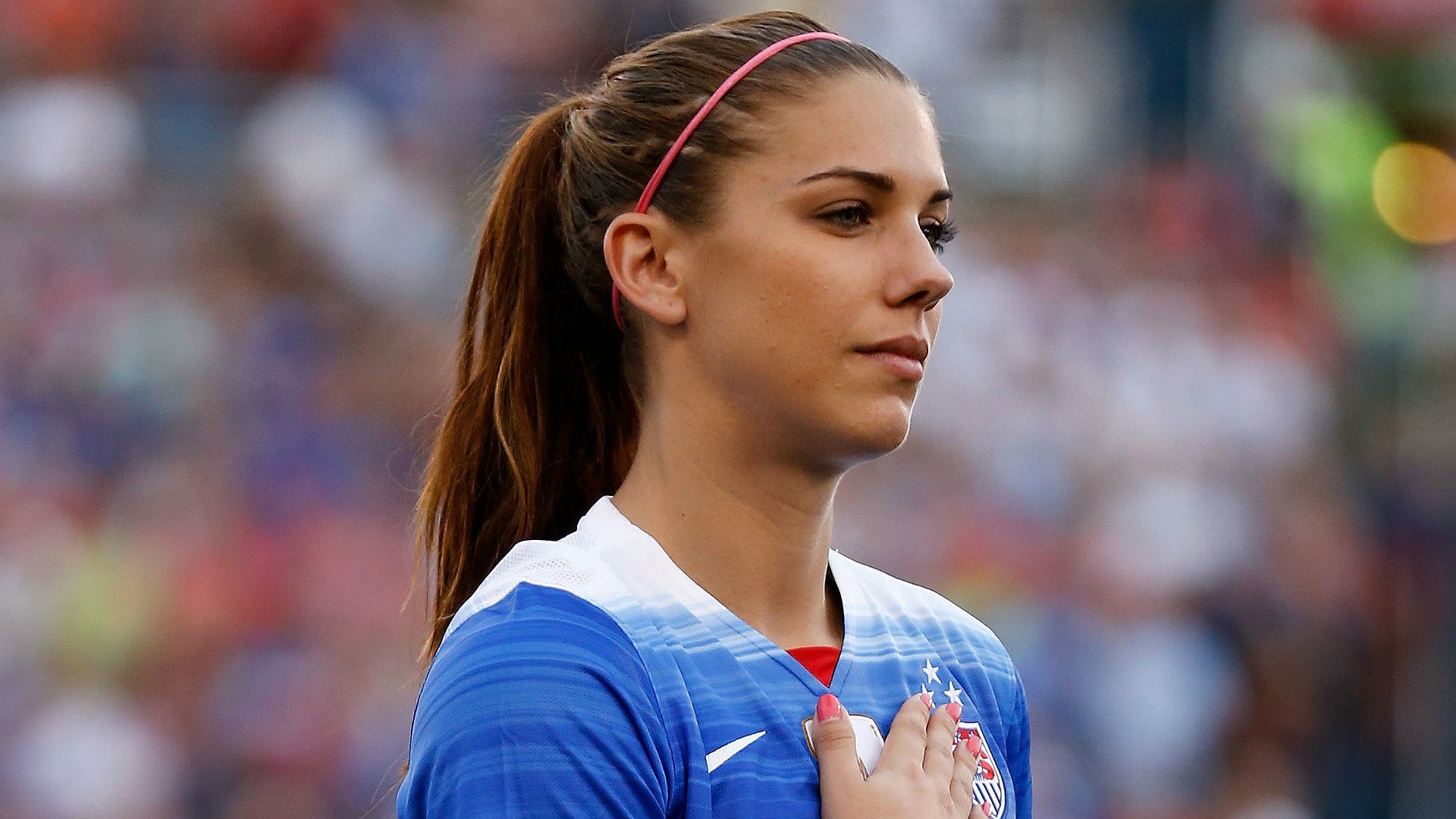 HD wallpaper of soccer player in blue jersey, poised for the national anthem, suitable as a desktop background.