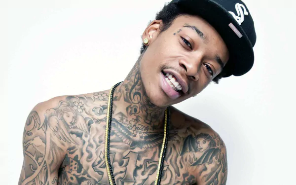 HD desktop wallpaper featuring a portrait of a tattooed individual wearing a cap, set against a white background.