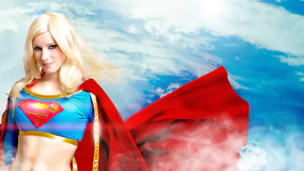 A woman cosplays Supergirl with blonde hair and blue eyes, set against a vibrant sky background. The HD wallpaper features Enji Night in a striking red and blue outfit with a flowing cape.
