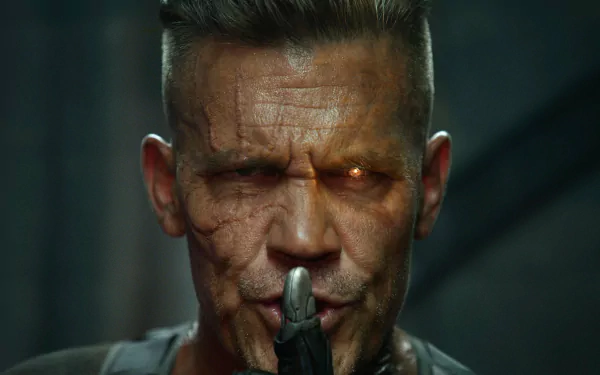 HD desktop wallpaper featuring Josh Brolin as Cable from the movie Deadpool 2. Cable, a Marvel Comics character, is depicted with a stern expression and cybernetic eye, holding a finger to his lips.