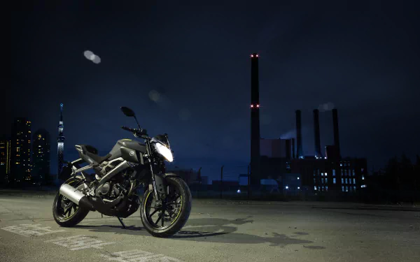 A Yamaha MT-125 motorcycle parked at night against an urban skyline, captured in 4K Ultra HD for a PC desktop wallpaper.