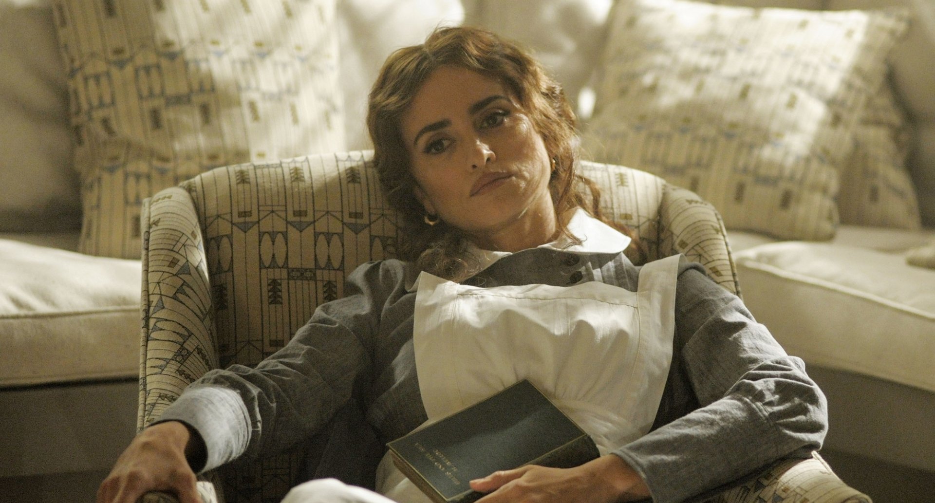 Penelope Cruz as a maid in the 2017 film Murder on the Orient Express, shown in an HD desktop wallpaper background.