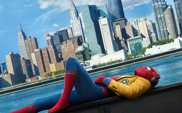 HD wallpaper of Spider-Man from the movie Spider-Man: Homecoming, depicting the superhero relaxing by a river with a cityscape in the background.