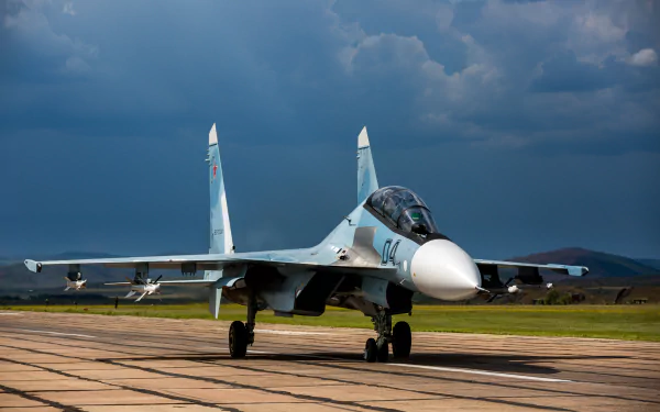 A Sukhoi Su-30 military jet fighter warplane on a runway under a cloudy sky, captured in 4K Ultra HD for a PC desktop background.