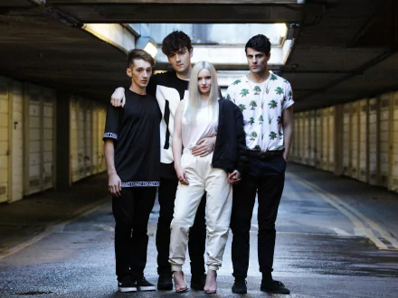 HD desktop wallpaper of Clean Bandit group standing together in an urban underpass setting.