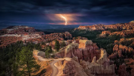 HD wallpaper of Bryce Canyon National Park showing a lightning storm over rugged rock formations and dark clouds.