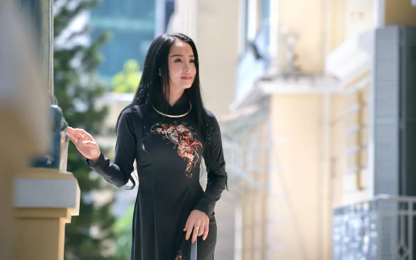Brunette model in a black traditional dress, soft depth-of-field bokeh and sunlit outdoor background — 5K Ultra HD PC desktop wallpaper and background.
