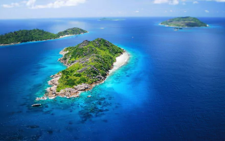 Aerial view of Seychelles islands and horizon over turquoise sea and deep blue ocean, lush vegetation and sandy shores — HD PC desktop wallpaper background of tropical nature.