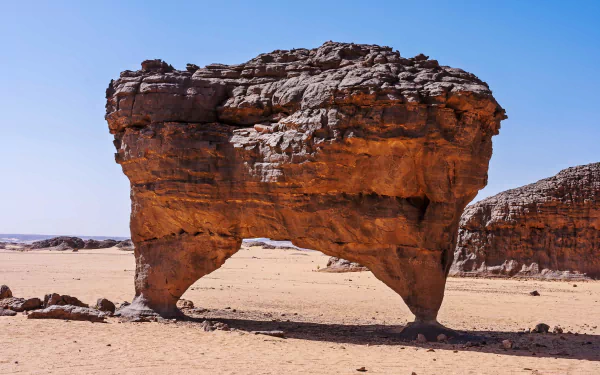 4K Ultra HD image of a natural stone arch in the Sahara Desert, Hoggar Mountains, Tassili N'Ajjer, Algeria, showcasing Africa's dramatic desert landscape.