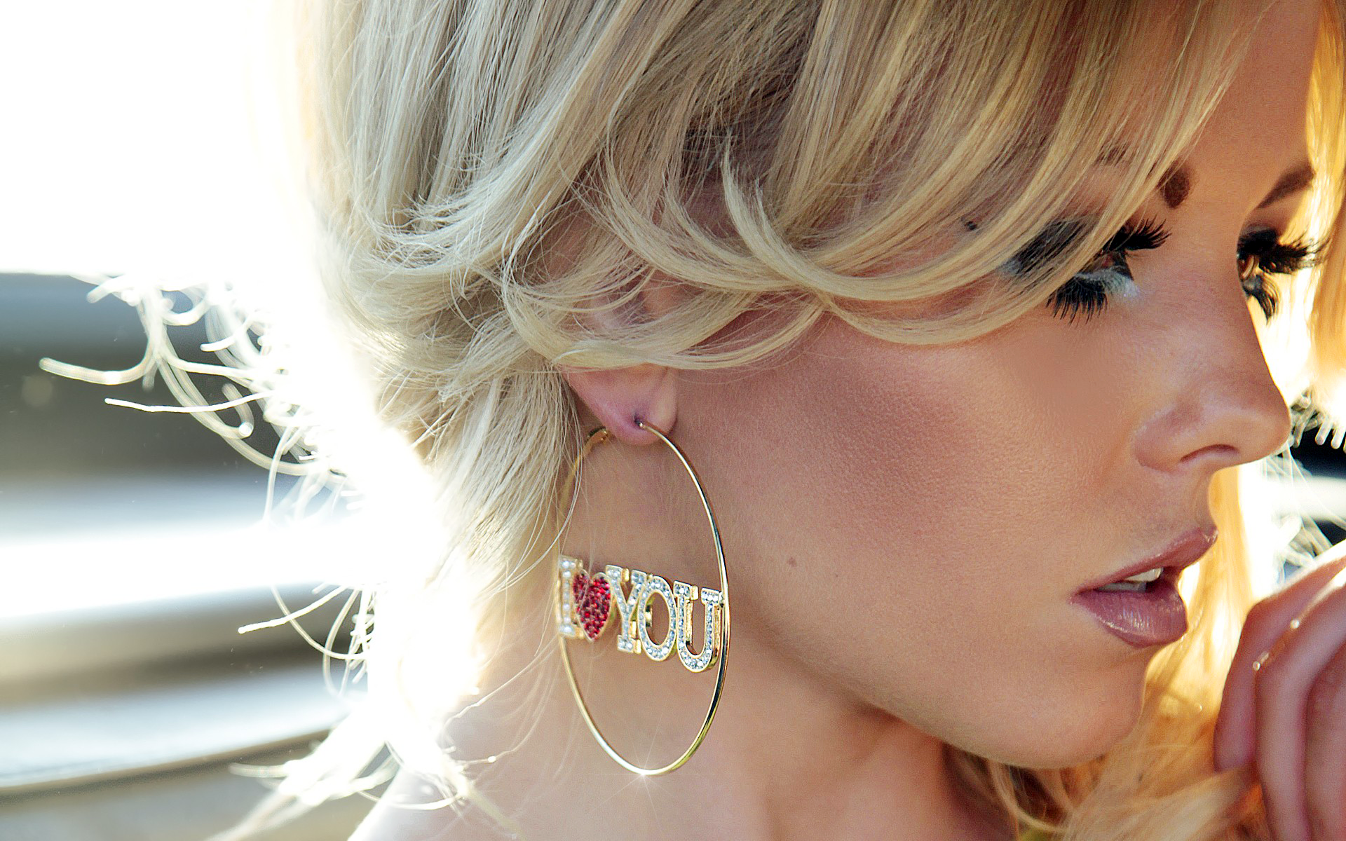 Blonde woman wearing earrings, captured in a close-up, HD desktop wallpaper and background.