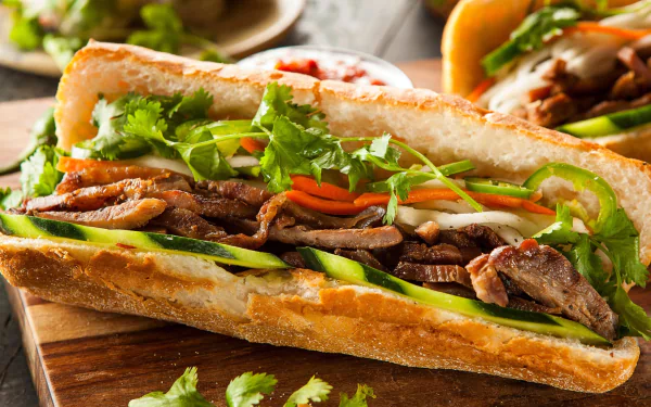 HD desktop wallpaper featuring a close-up still life of a sandwich with bread, sliced meat, fresh greens, and vegetables, showcasing vibrant food textures and colors.