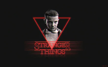 HD desktop wallpaper featuring Eleven from Stranger Things, portrayed by Millie Bobby Brown, with the show's title logo in red neon.