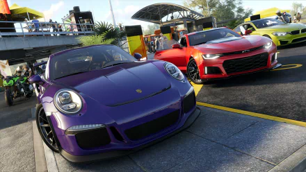 HD PC desktop wallpaper featuring a purple Porsche 911, yellow BMW M4, and red Chevrolet Camaro ZL1 lined up in a vibrant scene from The Crew 2 video game.