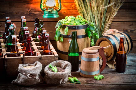 HD desktop wallpaper of a still life setup featuring bottles of beer, barrels, hops, and ingredients on a rustic wooden background.