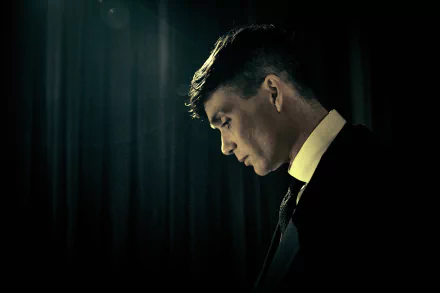 Thomas Shelby, portrayed by Cillian Murphy in Peaky Blinders, shown in a dark, moody 4K Ultra HD TV show wallpaper and background.