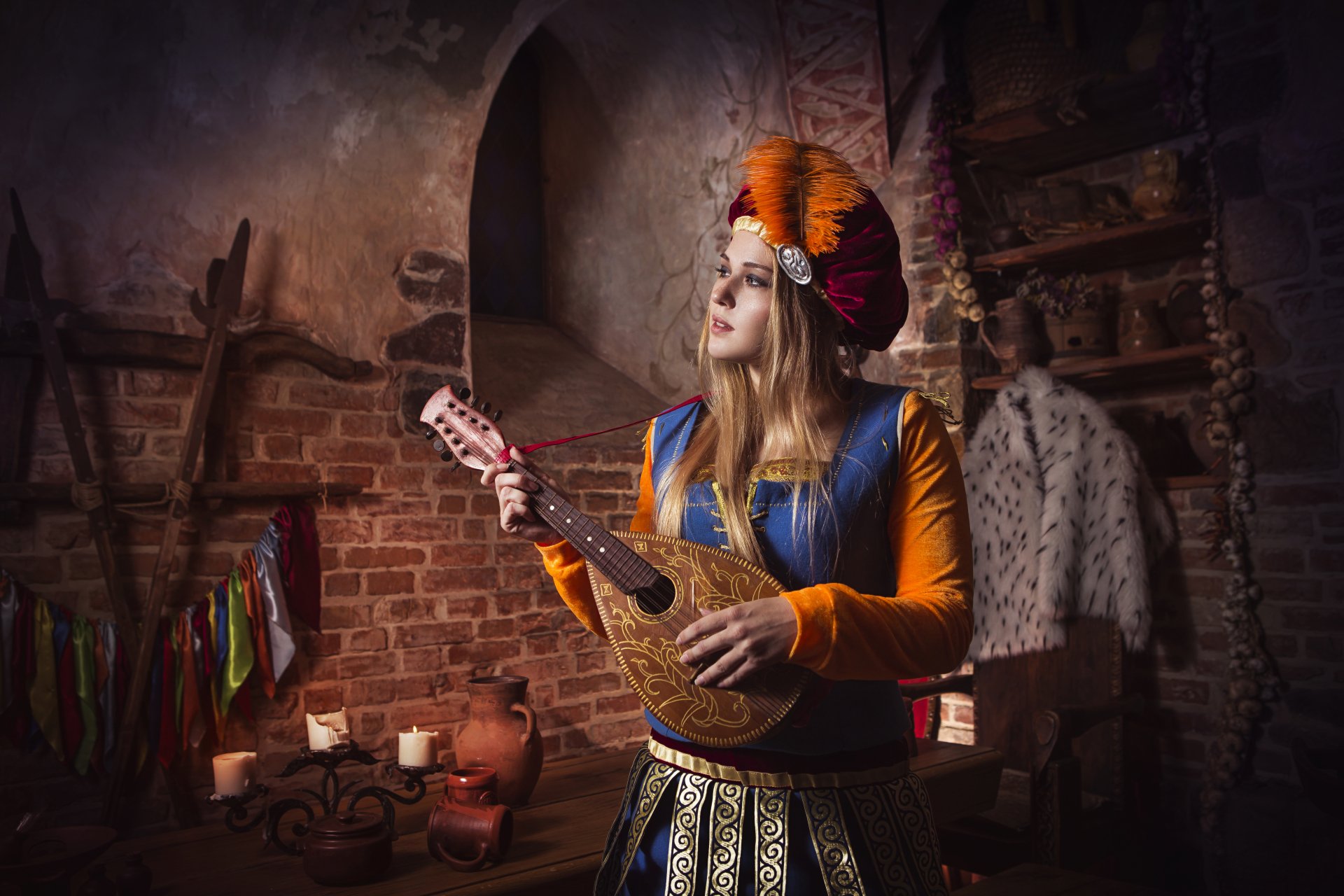 A 4K Ultra HD PC wallpaper featuring a woman in detailed The Witcher 3: Wild Hunt cosplay playing a stringed instrument in a rustic, medieval-style room.