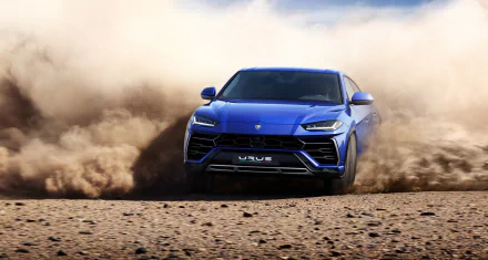 A dynamic HD wallpaper featuring a blue Lamborghini Urus SUV kicking up dirt, showcasing its power and performance on a rugged terrain.