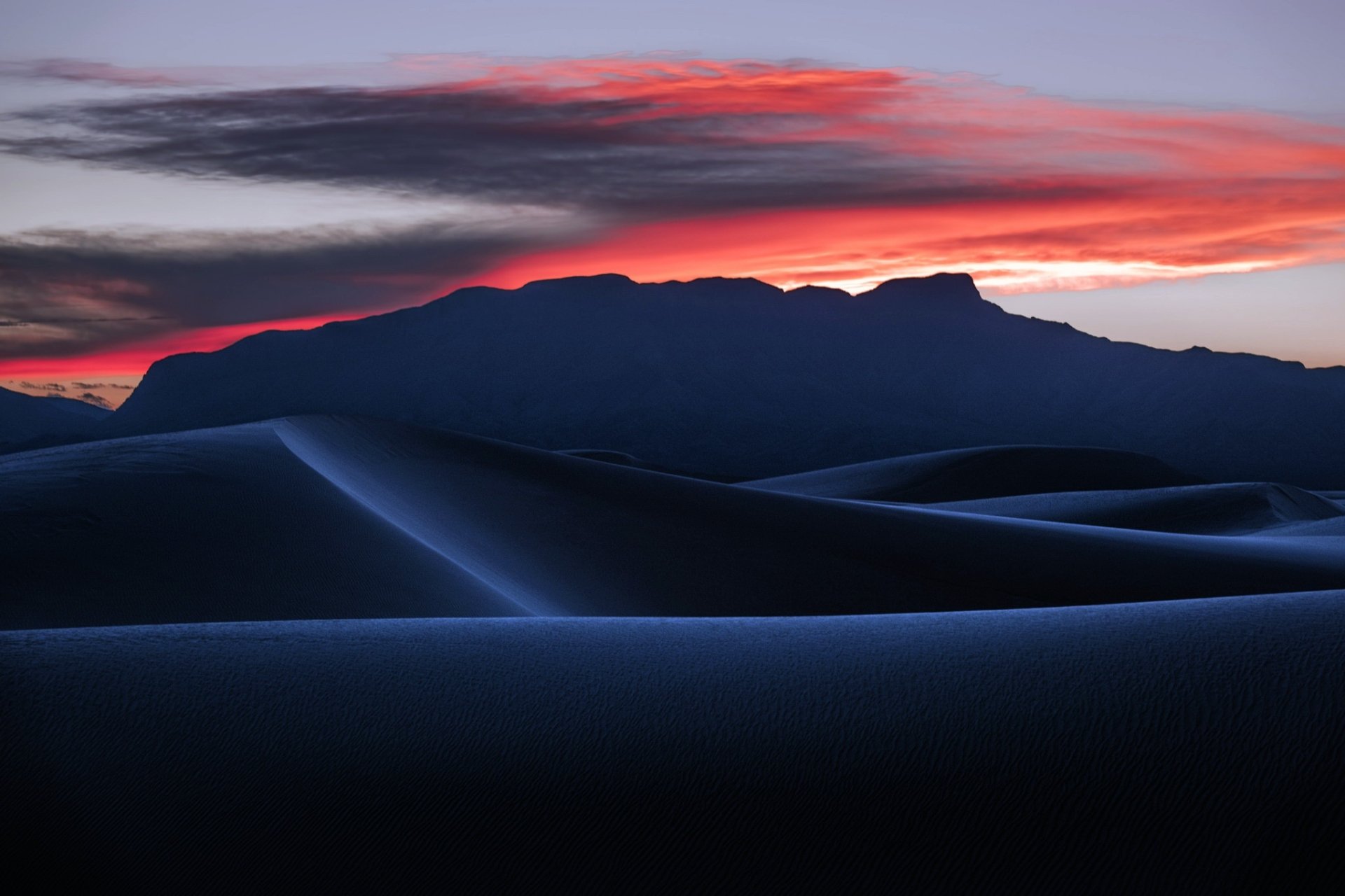 HD desktop wallpaper showcasing a desert landscape with smooth sand dunes under a vibrant sunset sky, highlighting the natural beauty of sand and nature.