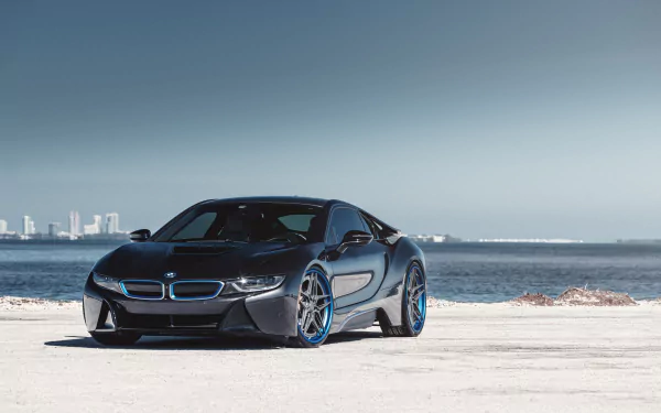 Sleek black BMW i8 supercar parked on a concrete surface by the water with a city skyline in the distance, captured in 4K Ultra HD for a stunning desktop wallpaper.