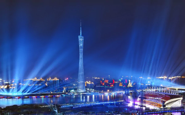 HD wallpaper featuring the illuminated Canton Tower at night in Guangzhou, China, with radiant blue lights beaming into the sky.
