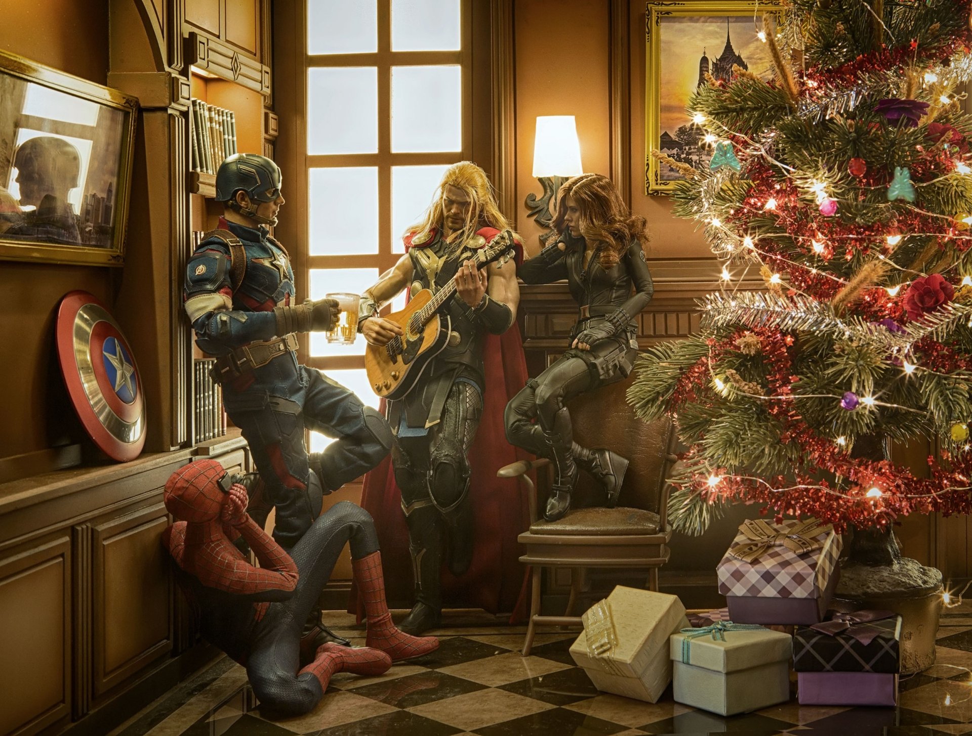 The Avengers, including Thor, Black Widow, Captain America, and Spider-Man, gather by a Christmas tree with gifts, celebrating amid festive decorations. This HD wallpaper captures a joyful holiday scene.
