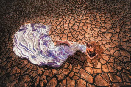  Woman Lying on Cracked Earth