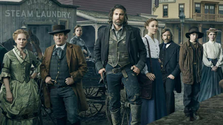 HD desktop wallpaper featuring the main cast of the TV show Hell on Wheels standing in a historic Western town setting.