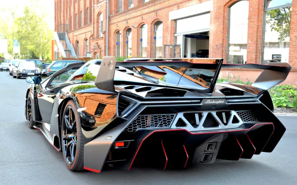 Sleek black Lamborghini Veneno Roadster supercar parked on a street, showcased in an HD PC desktop wallpaper background.