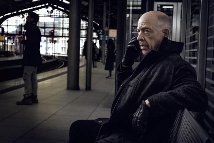 HD desktop wallpaper featuring a scene from Counterpart with a man on a phone at a train station.